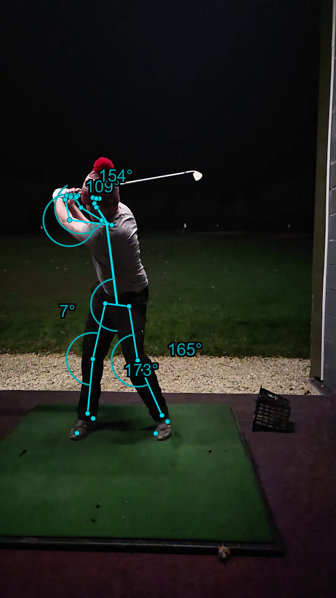 Top of backswing position with AI pose estimation measuring shoulder turn